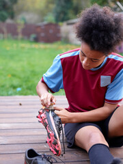 Wall Mural - Girl cleaning soccer cleats