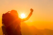 © artit - young female tourist carrying luggage at sunset