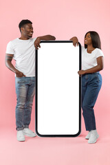 Wall Mural - Couple showing white empty smartphone screen leaning on display