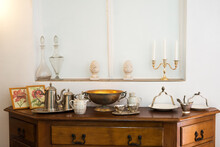 Interior Detail With Antique Cabinet And Exquisite Ceramic, Glass And Metal Dishes - Selective Focus