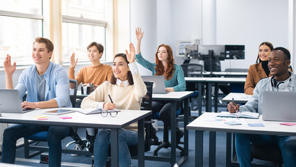 Portrait of diverse people raising hands at seminar