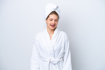 Wall Mural - Teenager Russian girl in a bathrobe isolated on white background laughing