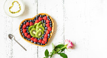 S.Valentine's Day Breakfast Concept. Mix Of Berries And Kiwi In A Heart Shaped Bowl And Rose