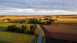 Aerial panorama of Swedish countryside, Swedish village at sunrise, clear blue sky, green yellow fields. View of typical landscape of southern Sweden. 