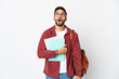 © luismolinero - Young student man isolated on white background looking up and with surprised expression