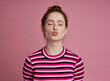 © gpointstudio - Studio shot of young girl blowing kisses in striped shirt