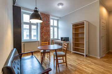 Fully renovated living room in sunny apartment in old tenement building.