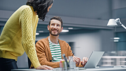 Poster - Modern Office: Business Meeting of Two Businesspeople Talking at the Desk. Businessman and Businesswoman Work on Strategy, Brainstorm for e-Commerce Software Design. Shot with Motion Blur Background