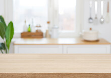 Empty Wooden Desk On Blurred Kitchen Window For Product Presentation