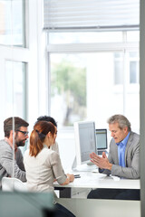 Aufkleber - Laying down his ideas. A group of businesspeople going over some plans together.