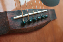 Brown Acoustic Guitar And Strings Close-up.