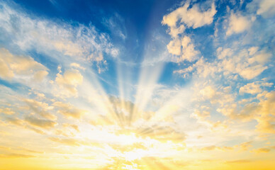 Wall Mural - Sky blue and orange light of the sun through the clouds in the sky
