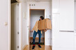 © ADDICTIVE STOCK - Young female moving in new apartment