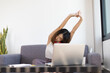 © Wasan - Woman doing stretches to relax from work at home. Work from home and social distancing concept for quarantine.