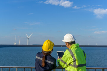 people engineer are wearing a protective helmet on head, using tablet Analytics engineering data...