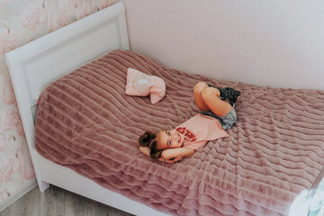 a girl wakes up after sleeping in her bed