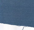 © MD - a piece of blue jeans denim isolated on white background