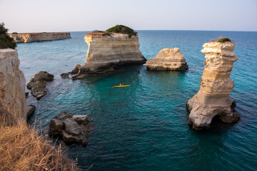 Beautiful rocky sea coast in Italy with clear water and stacks