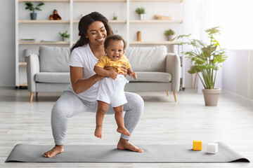 Wall Mural - Weight Loss After Pregnancy. Black Mom Training At Home With Infant Baby