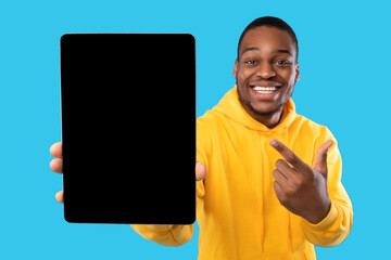 Black Guy Showing Digital Tablet With Blank Screen, Blue Background