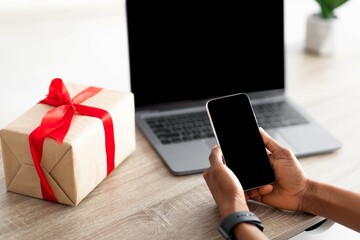 Poster - Closeup of Afro woman using mobile phone, laptop and credit card to buy gifts online, mockup for shopping app or website
