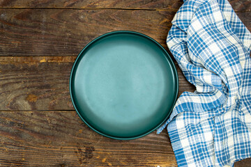 Poster - Empty ceramic blue plate on wooden planks table