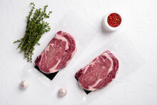 Vacuum Plastic Pack With Fresh Beef Steak, On White Stone Table Background, Top View Flat Lay