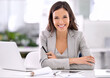 © Yuri A/peopleimages.com - She's made it. Shot of an attractive businesswoman sitting at her desk in an office.