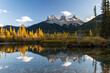 Sunset view in Canadian Rockies with Three Sisters peaks reflecting in water, Canmore, Alberta, Canada.