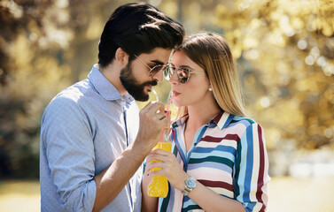 Dating. Loving couple drinking juice together. Love and romance