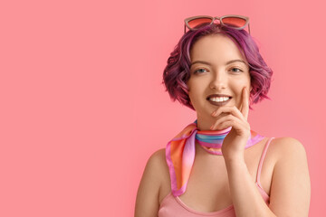 Beautiful young woman with violet hair on pink background. Very Peri - color of year 2022