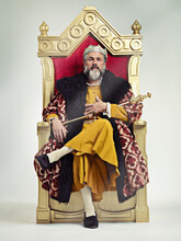I Took The Throne Peacefully. Studio Shot Of A Richly Garbed King Sitting On A Throne.