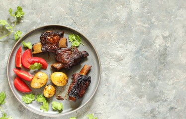 Wall Mural - short ribs stew with new potatoes.
long stewed meat. serving with tomatoes and herbs