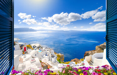 View through an open window with shutters of the caldera, sea and white village of Oia on the island of Santorini, Greece.