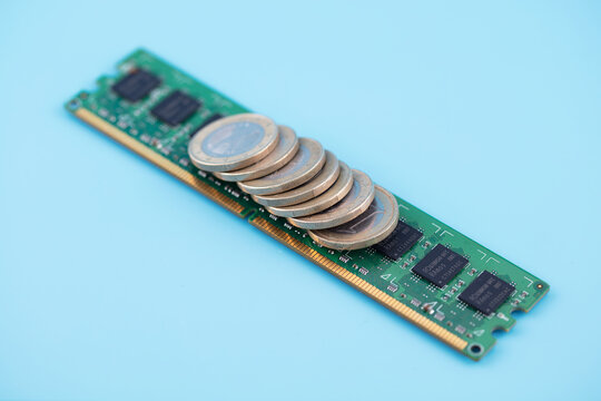 Euro coins and computer graphics cards on a blue background