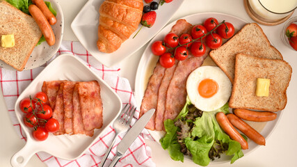 Top view, breakfast and pastries set prepared on dining table.