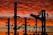 Steel Pylons Silhouettes And Catenaries Over A Colorful Sunrise Background, Illustrating The Major Disruption To Happen In Railways Industry Worldwide In The Coming Years