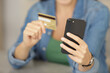 © auremar - woman buying online with credit card and smart phone