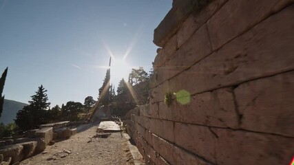 Wall Mural - Delphi - moving along the ruins to reveal big teatro at sunset