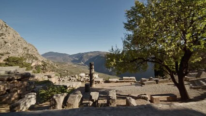 Wall Mural - Delphi - taking a look around the ruins at sunset
