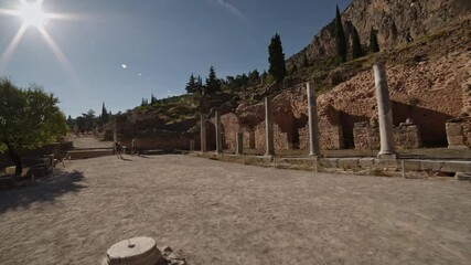Wall Mural - Delphi - exploring the ruins of ancient buildings at sunset