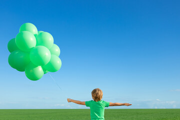 Canvas Print - Happy child playing outdoors in spring field