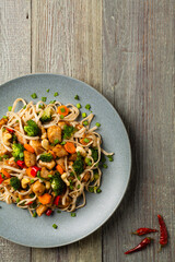 Wall Mural - stir-fry pasta with chicken, broccoli and carrots.