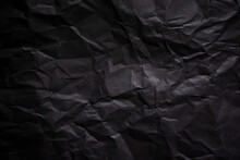 Textured Crumpled Black Paper Background.