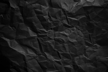 Poster - Textured crumpled black paper background.