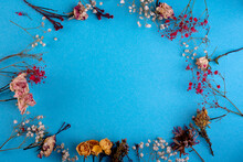 Frame Of Dried Flowers On A Blue Background