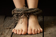 children's feet bound with an old dirty rope, slavery and theft of people