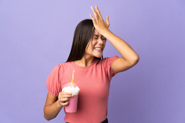 Wall Mural - Teenager girl holding a strawberry milkshake has realized something and intending the solution