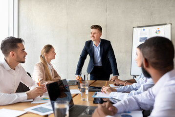 Aufkleber - Corporate Meeting Concept. Confident Businessman Talking To Diverse Coworkers In Conference Room