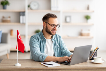 Poster - Millennial male tutor with laptop teaching Turkish online from home